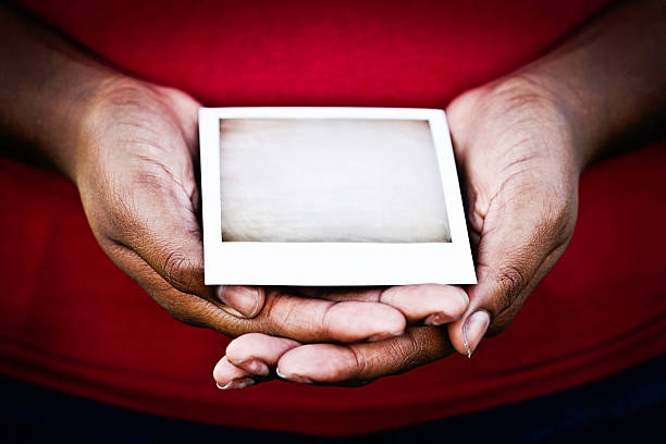 Female Hands Holding Blank Photograph
