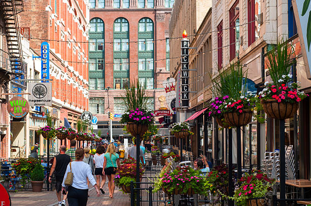 East 4th Street Cleveland, OH, USA - August 10, 2013: The trendy scene of East Fourth Street in Cleveland with its clubs, cafes, and entertainment venues attracts visitors even on a Saturday morning. cleveland ohio stock pictures, royalty-free photos & images