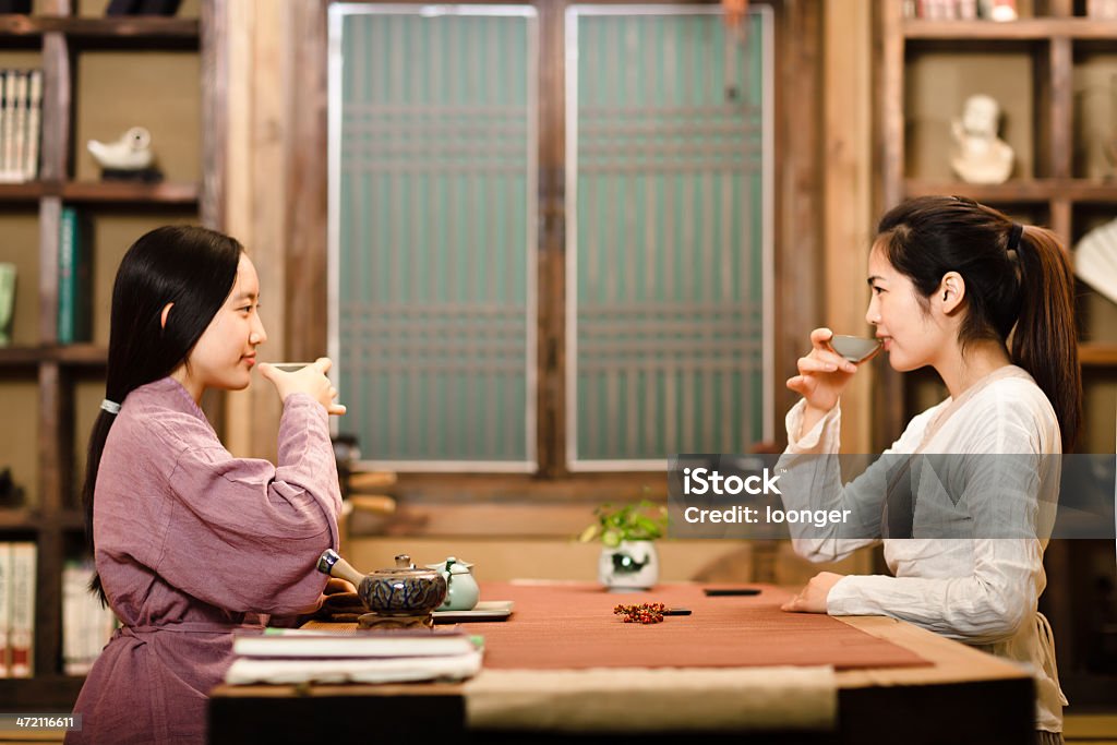 Two east asian girl showing Tea Ceremony Two east asian girl dress in Hanfu showing Tea Ceremony in the tearoom 16-17 Years Stock Photo