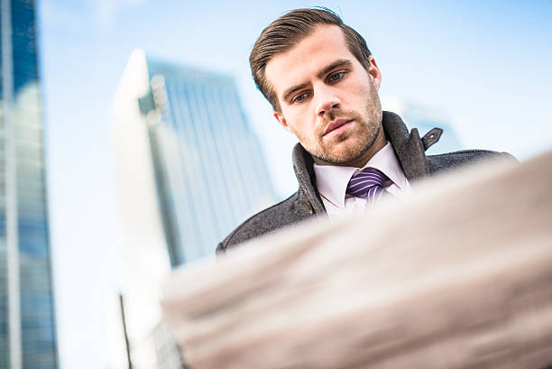 istock business man reading newspaper on downtown 472118185
