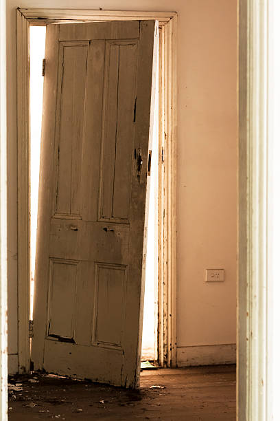 istock Damaged door in abandoned  building with sunlight from outside 472118291