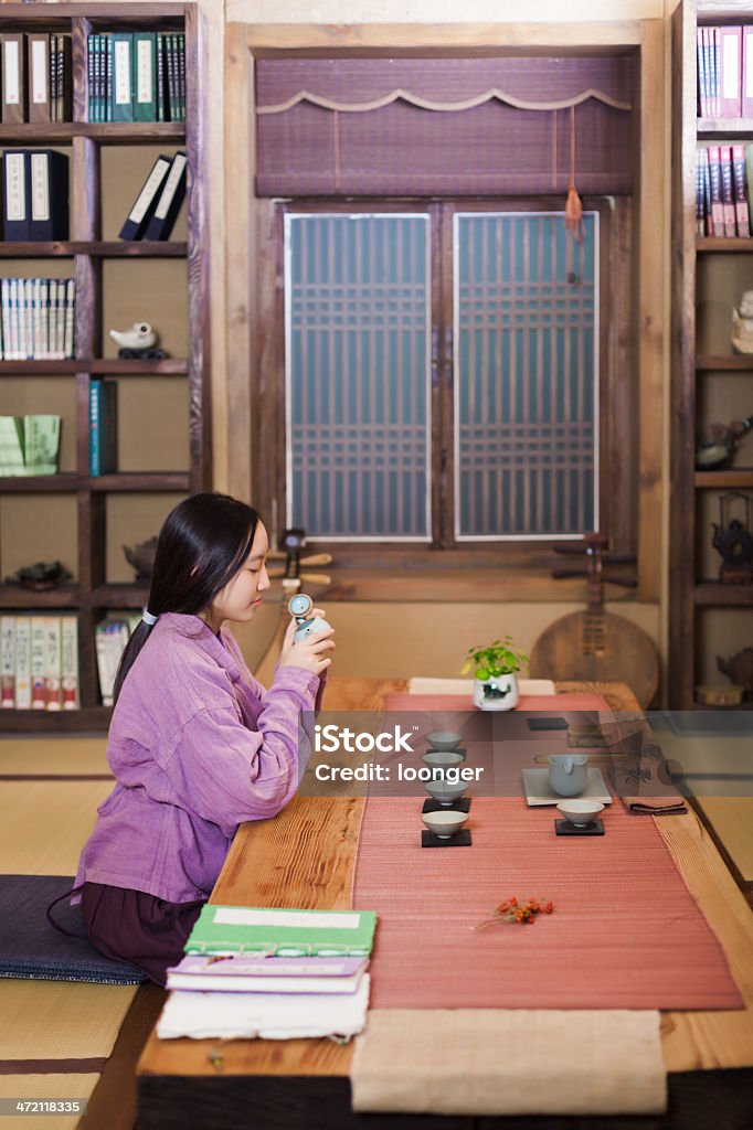 East asian teenage girl showing Tea Ceremony East asian teenage girl dress in Hanfu showing Tea Ceremony in the tearoom 16-17 Years Stock Photo