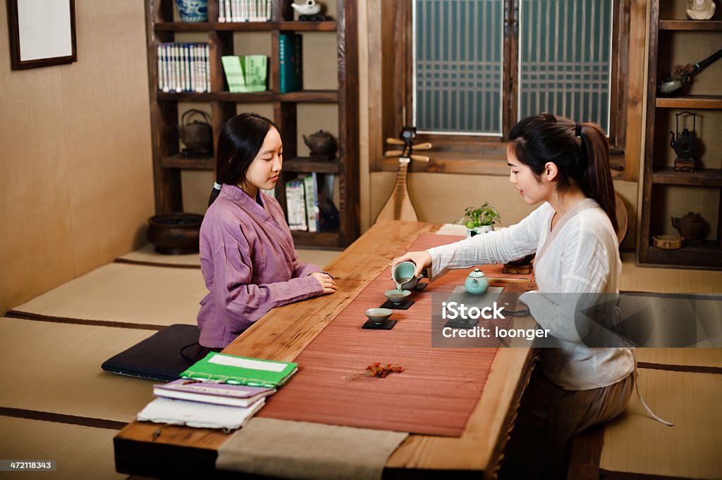 Two east asian girl showing Tea Ceremony Two east asian girl dress in Hanfu showing Tea Ceremony in the tearoom.No.1 16-17 Years Stock Photo