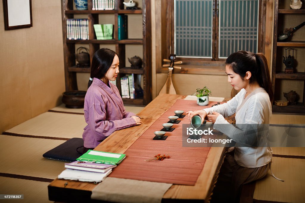 Two east asian girl showing Tea Ceremony Two east asian girl dress in Hanfu showing Tea Ceremony in the tearoom, No.2 Clothing Stock Photo