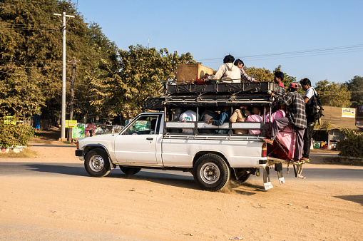 Mandalay, Myanmar - January 7, 2014: Local Myanmar people used small truck as mass transportation in town of Mandalay, Myanmar.