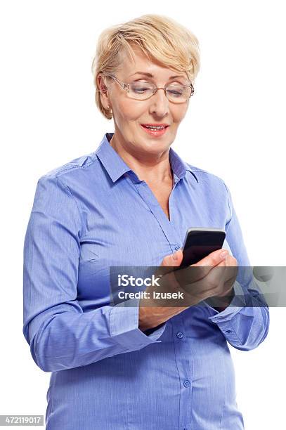 Senior Businesswoman With Smart Phone Stock Photo - Download Image Now - White Background, Mobile Phone, Text Messaging