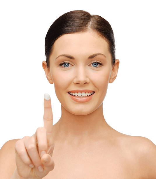 istock beautiful woman with moisturizing creme drop 472119111