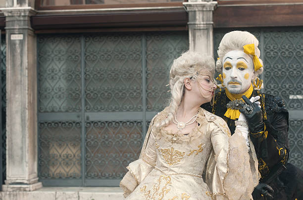 Venice Carnival 2013 Venice, Italy - February 4, 2013: The photo was taken during the famous Venice carnival. We can see attractive masked couple who posing on Campo San Zaccaria. Venice, Italy. mardi gras body painting stock pictures, royalty-free photos & images
