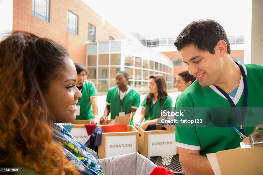 Volunteers: College students collect clothing donations. Organized group of multi-ethnic college student volunteers collect clothing donations for needy families in their community.   20-24 Years Stock Photo