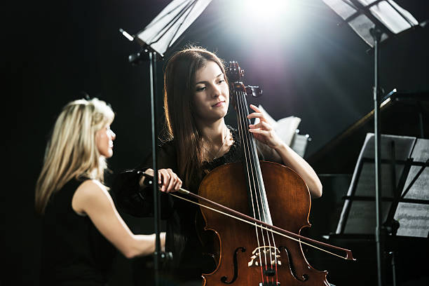 istock Young woman playing cello. 472120215