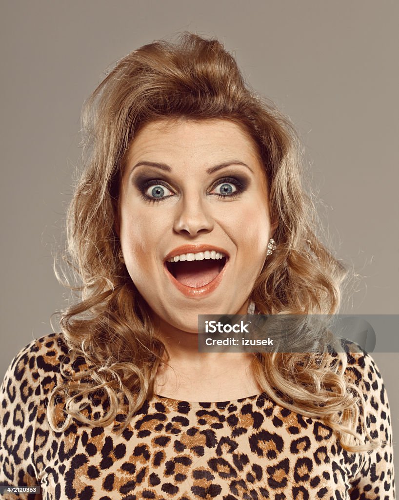Excited Woman Portrait of surprised woman wearing leopard print dress staring at camera with mouth open. Studio shot. 20-29 Years Stock Photo