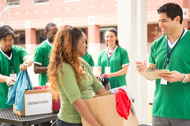 istock Volunteers: College students collect clothing donations for community. 472121031