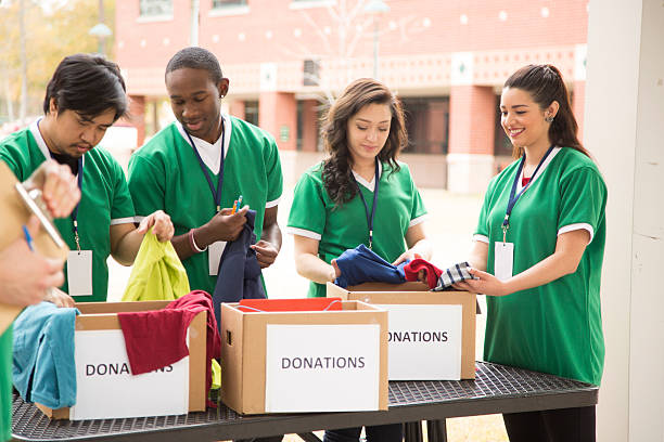 istock Volunteers: College students collect clothing donations for community. 472121059