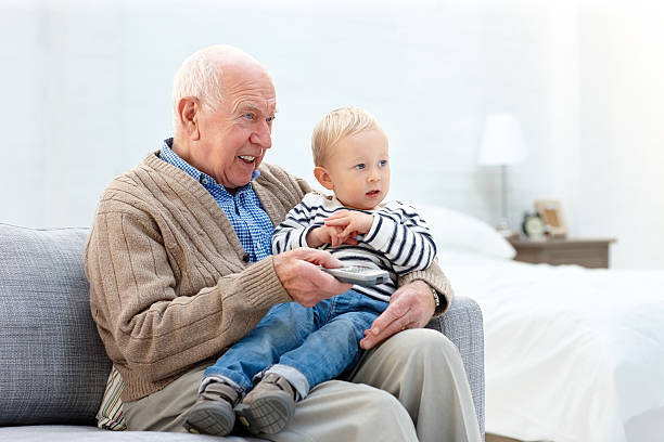 istock Relaxed grandfather and grandson watching TV 472122577