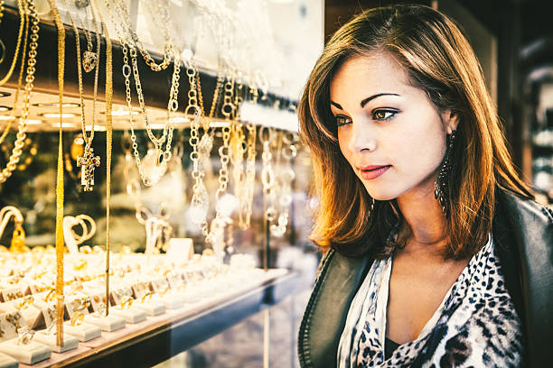 istock Determined Young Woman Looking at Elegant Jewelry 472125311