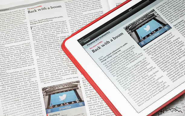 White iPad Air and The Economist magazine displaying same article stock photo