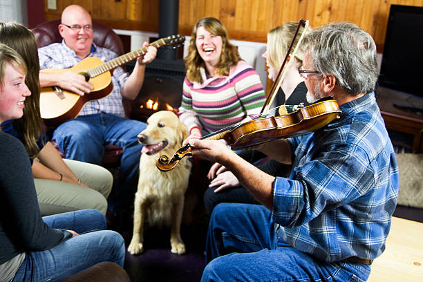 feliz grupo de personas divirtiéndose juntos jugando música - violin family fotografías e imágenes de stock