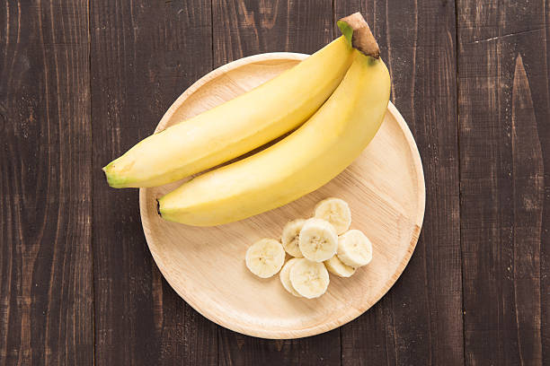 istock Top fresh bananas on wooden background 472126590