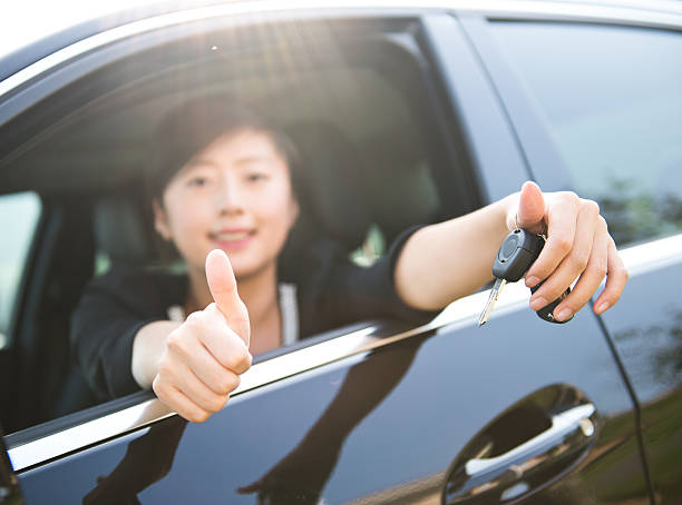 istock young woman with keys 472126631