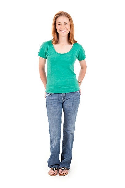 istock Confident young woman with hands in pockets, isolated on white 472127151