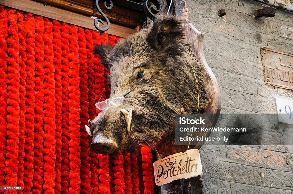 Siena Butcher Shop Siena, Italy-June 4, 2011:A distinctive butcher  shop sign in Siena features a comical boar's head wearing glasses with a sign reading "Oggi Porchetta"  meaning that the shop's porchetta is available today. Siena - Italy Stock Photo