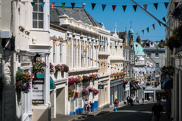Smith Street, St. Peter Port, Guernsey St. Peter Port, United Kingdom - July 10, 2013: Smith Street, St. Peter Port, Guernsey. Decorated for summer, view downwards to The Pollet and High Street. guernsey city stock pictures, royalty-free photos & images