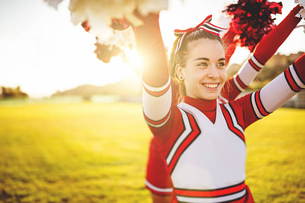 istock Happiness cheerleader posing with pon-pon 472128151