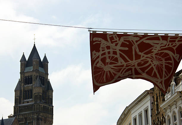 St. Salvator's Cathedral Bruges, Belgium - June 4, 2013: An artistic banner in Bruges street with the view of a tower, the tower is on St. Salvator's Cathedral in Bruges, Belgium. st salvator's cathedral stock pictures, royalty-free photos & images