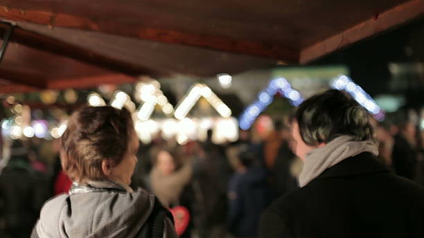 istock Young couple watching a winter market at night 472128719