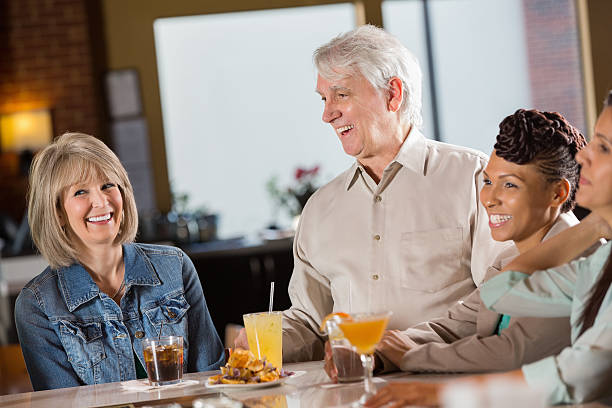 istock mature couple laughing together at a restaurant 472128869