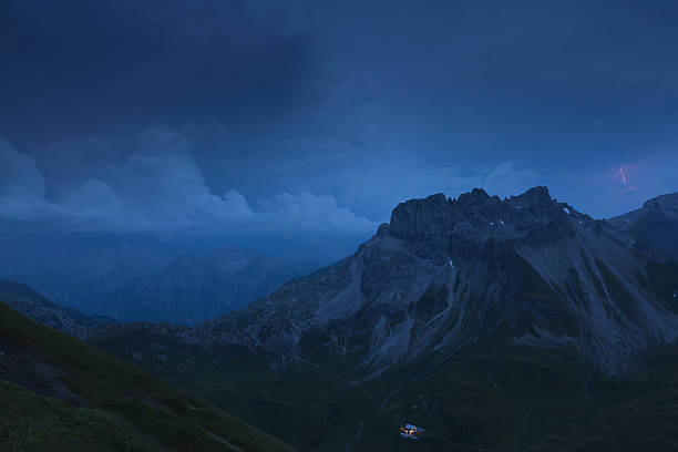 thunderstorm with lightning above the lechtaler alps, kemptner hut in the foreground