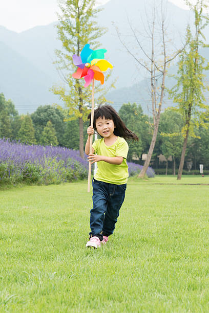 Colorful paper flowers form a windmill, leaving the copy space.