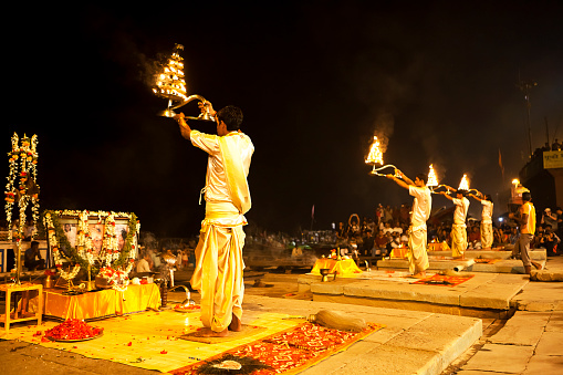 Varanasi, India - October 28, 2013: Hindu priest conducts religious Ganga Aarti ritual (fire puja) at Dashashwamedh Ghat. 
