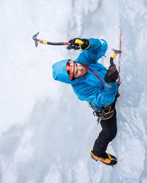 un macho escalador escalada sobre hielo congelado cascade - motivation passion cold inspiration fotografías e imágenes de stock