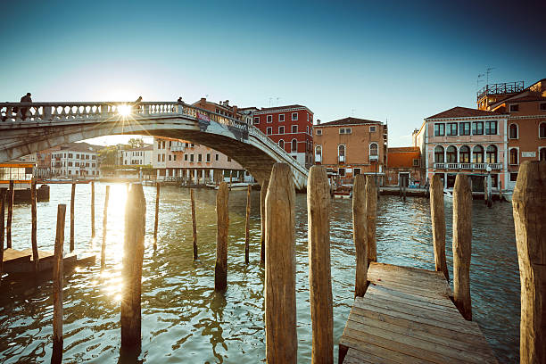 This is a close-up image of the front of a gondola on a narrow canal in Venice, Italy. Heavily post processed to give a painterly effect.