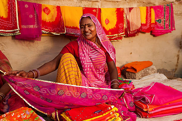 istock Woman selling colorful fabrics 472133391
