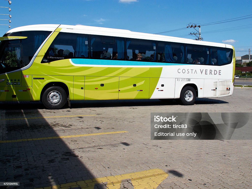 Brazilian coach travel Paraty, Brazil - November 19, 2012: Modern coach of the Costa Verde bus company which operates betwwen Rio De Janeiro to Paraty is parked at a motorway stop. Passengers are pictured on the bus Adult Stock Photo