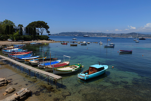 Antibes, France - July 1, 2013; traditional wooden fishing boats in picturesque Port de l'Olivette near Antibes along the French Cote d'Azur