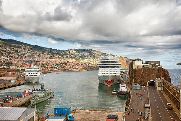 Funchal,Portugal - January 13, 2014: Harbor of Funchal, Madeira. It is the only major port of Madeira. There landing cruise ships ; nautical vessels ,ferries and other tourist-related boats . People are walking to the ships or watching the harbor .