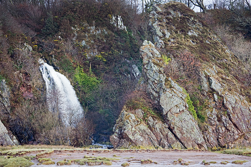 Waterfall by Southwick Water near RSPB Mersehead Nature Reserve, Southwick, Dumfries and Galloway, Scotland, UK. Landscape.