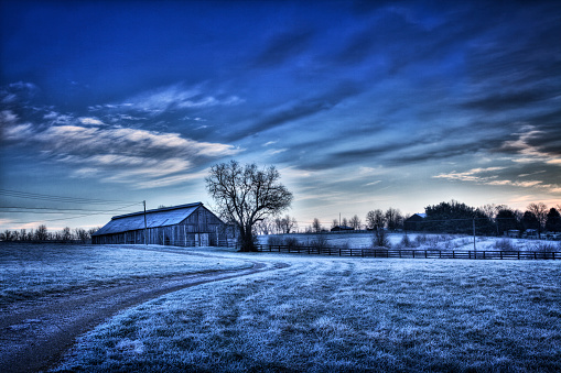 Old barn in winter landscape.