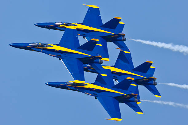 US Navy Blue Angels performing demo routine Patuxent River, USA - September 4, 2011: US Navy Blue Angels performing demo routine flying F-18 Hornets with special livery celebrating colors of US Navy on September 4, 2011 in Patuxent River, Maryland. Blue Angels is the oldest and is considered the best Demonstration Squadron in the world. fa 18 hornet stock pictures, royalty-free photos & images