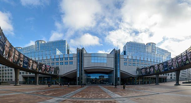 European Parliament building in Brussels Brussels, Belgium - January 13, 2014: Square in front of the European Parliament buildings in Brussels. People are walking in different directions on the square. european union symbol stock pictures, royalty-free photos & images