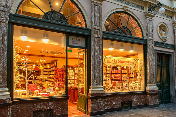 Brussels, Belgium - September 16, 2017:  Chocolate store in Brussels, viewed from the street through store window, with people inside the store.