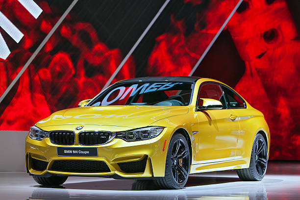 BMW M4 Coupe 2014 Detroit Auto Show Detroit, MI, USA – January 13, 2014: The World premiere of the new BMW M4 Coupe at the North American International Auto Show in Detroit Michigan. 2014 stock pictures, royalty-free photos & images