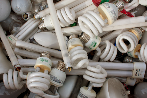 Lawrenceville, GA, USA - November 23, 2013:  A mixture of discarded light bulbs to be recycled fills a box at Gwinnett County's America Recycles Day event.
