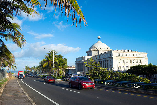 San Juan, Puerto Rico - November 17, 2013: Cars travel past the Capitol Building (El Capitolio) in San Juan, Puerto Rico.