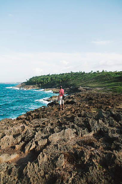 istock Man taking a picture of the beach 472139349