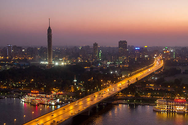 Cairo, Egypt - August 29, 2010: Dusk over the busy skyline of Cairo with illuminated boats on river Nile