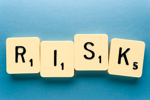 Kendal, UK - January 22, 2014: Close-up of vintage plastic Scrabble letters, arranged on a blue background, spelling the word 